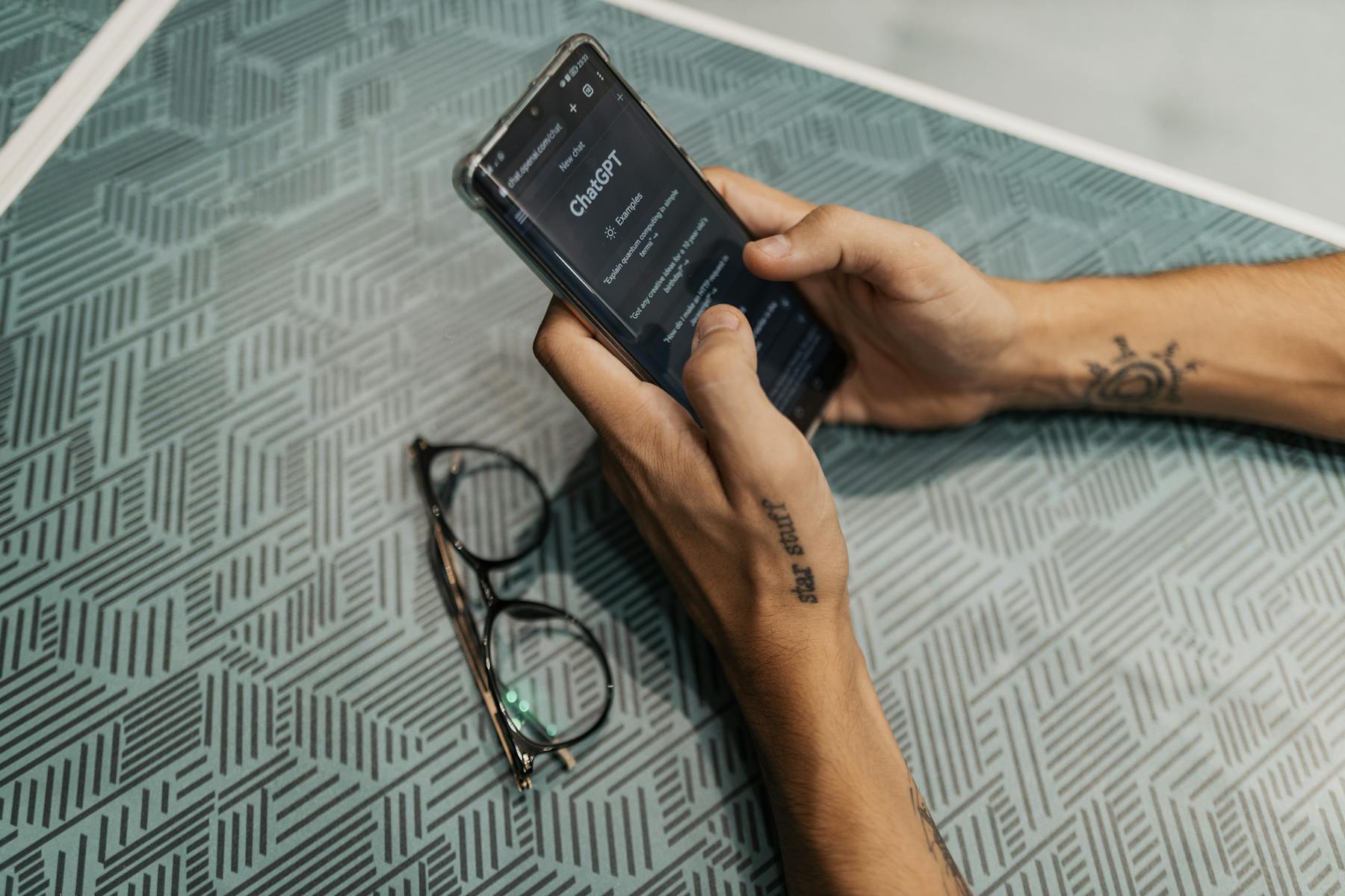 Person holding smartphone using ChatGPT AI search interface, demonstrating how conversational queries have changed content strategy for growing businesses. Image by Bertelli Fotografia (https://www.pexels.com/@bertellifotografia)